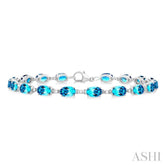 6X4 MM Oval Cut Blue Topaz and 1/6 ctw Round Cut Diamond Semi Precious Tennis Bracelet in 10K White Gold